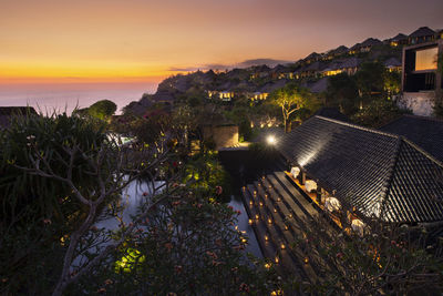 High angle view of illuminated buildings against sky during sunset