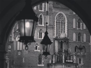 Low angle view of hanging lanterns against built structure