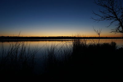 Scenic view of lake at sunset