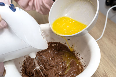 Mixing the dough with a hand mixer with a whisk with melted butter added, the dough is a thick mass.