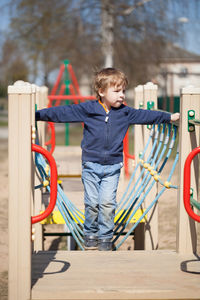 Full length of boy standing in playground