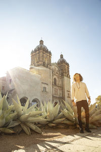 Full length of man against temple building against clear sky