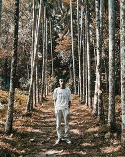 Portrait of man standing in forest