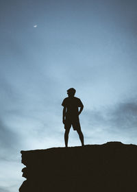 Low angle view of silhouette man standing against sky