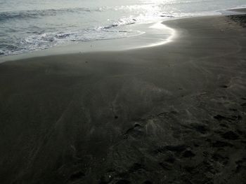 Close-up of sand on beach against sky