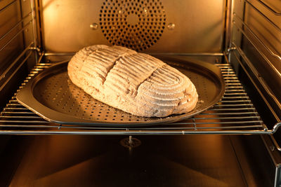 Raw bread dough on sheet in backing oven