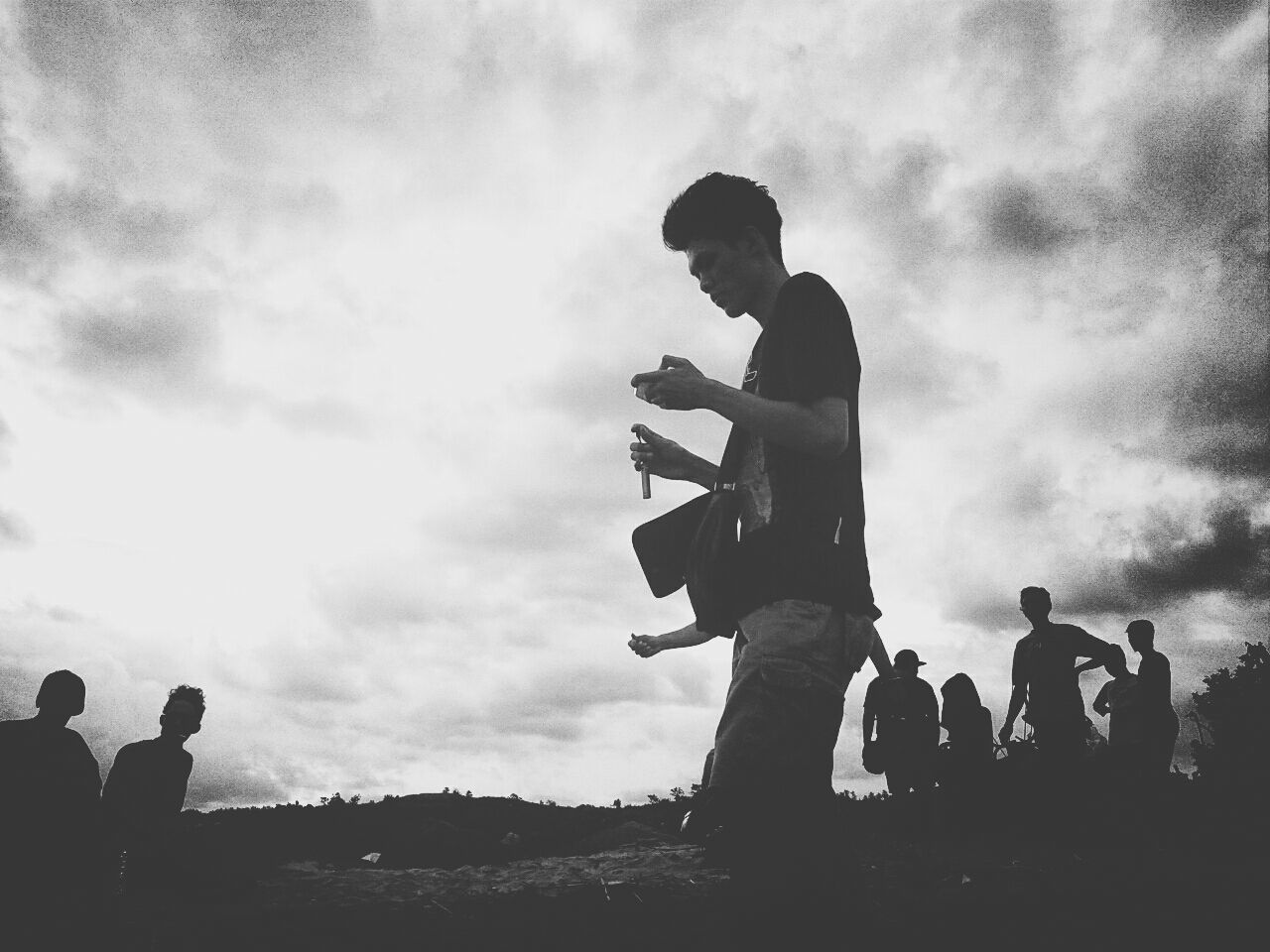 sky, lifestyles, leisure activity, men, silhouette, togetherness, cloud - sky, low angle view, bonding, cloudy, standing, person, childhood, boys, love, sitting, friendship, full length