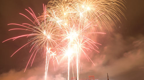 Low angle view of firework display at night