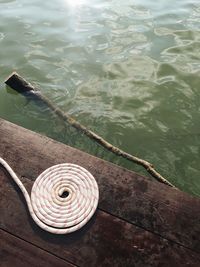 High angle view of rope tied on pier over lake