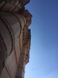 Low angle view of historical building against blue sky