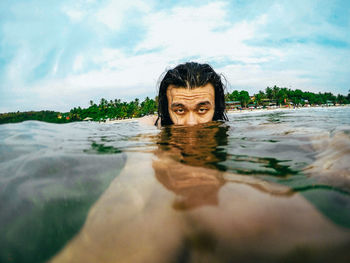 Portrait of man swimming in sea