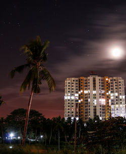 Low angle view of city lit up at night