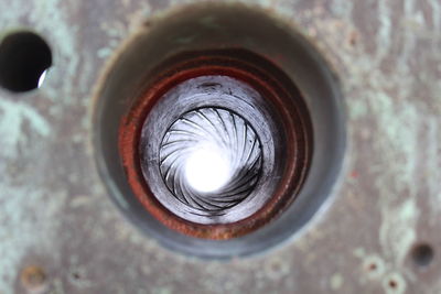 Directly above shot of rusty metal hole on wall