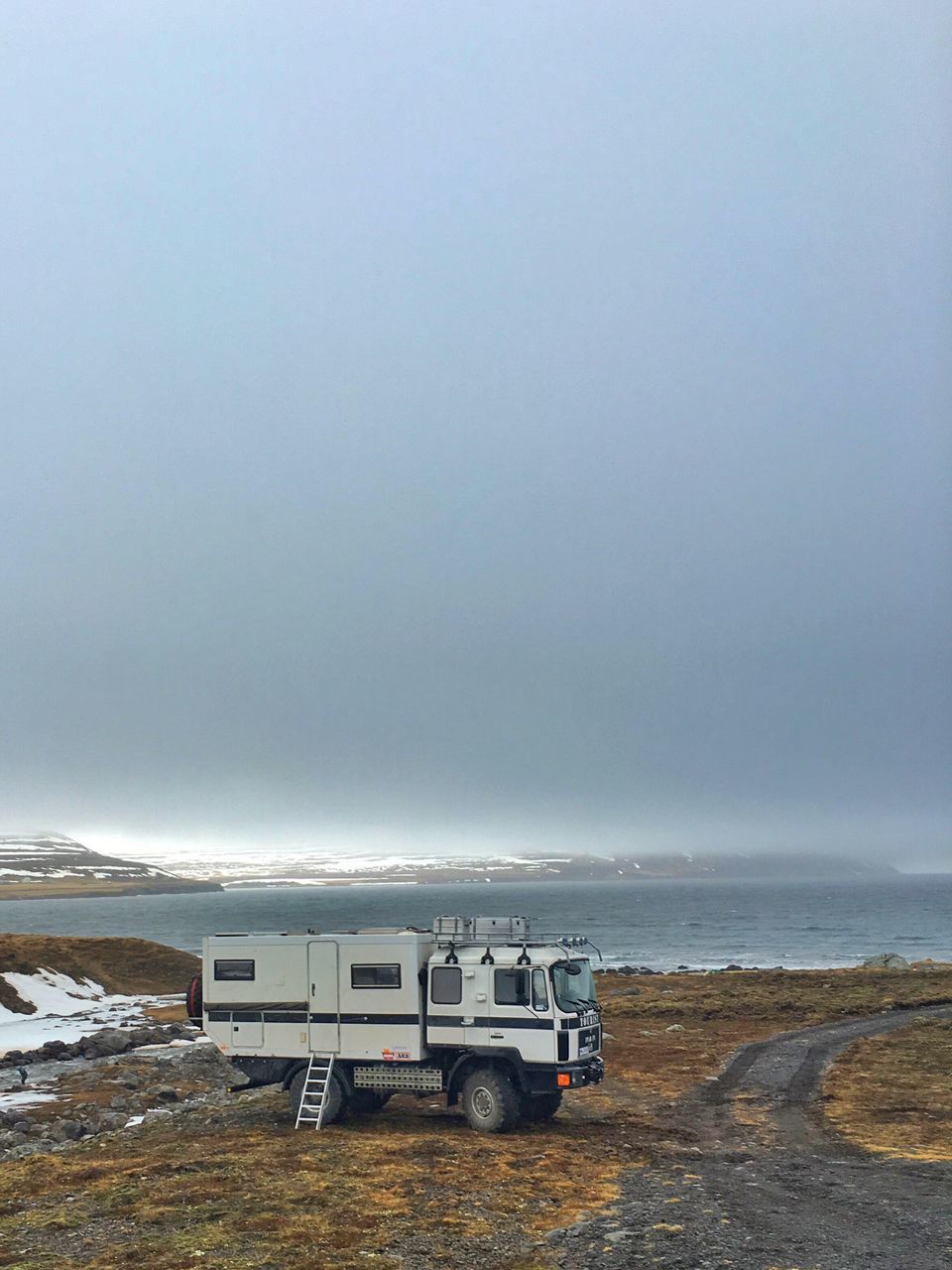 sky, weather, transportation, overcast, cloud - sky, sea, mode of transport, beach, nature, cloudy, scenics, beauty in nature, horizon over water, tranquility, land vehicle, tranquil scene, car, water, copy space, shore