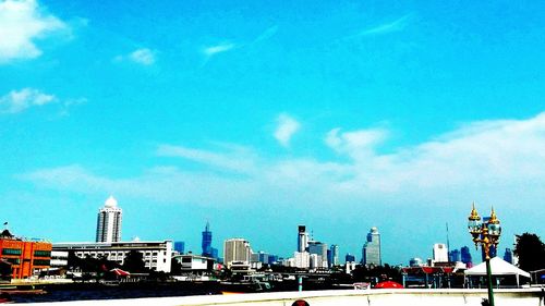 View of cityscape against blue sky