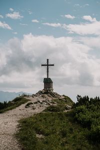 Cross in temple against sky