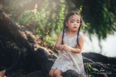 Cute girl sitting outdoors