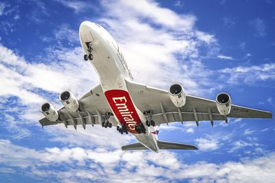 Low angle view of airplane flying against sky