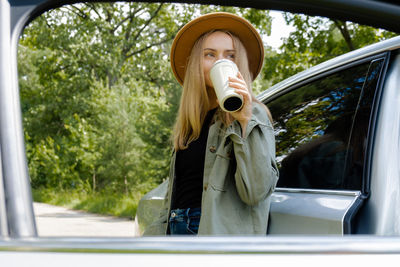 Low angle view of woman drinking water