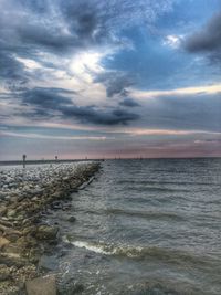 Scenic view of calm sea against cloudy sky