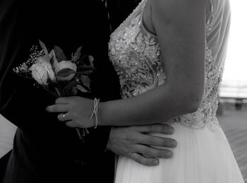 Midsection of couple dancing at wedding ceremony