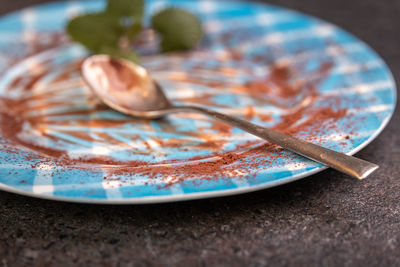 Close-up of fork in plate on table