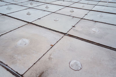 Jingzaijiao tile paved salt fields with dry salt ready for harvesting in cloudy weather in tainan city in taiwan