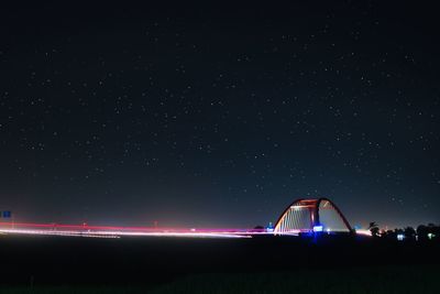 Illuminated built structure against sky at night