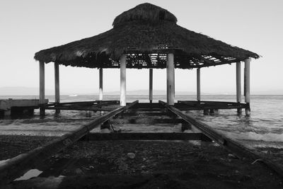 Built structure on beach against clear sky