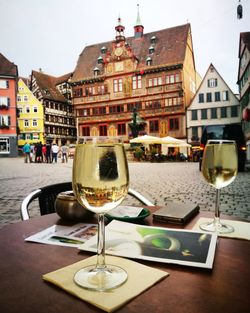 Close-up of beer on table in city