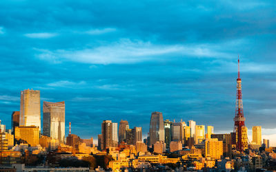 Cityscape against cloudy sky