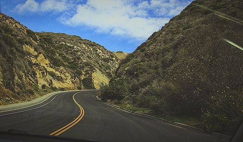 Road amidst mountains against sky