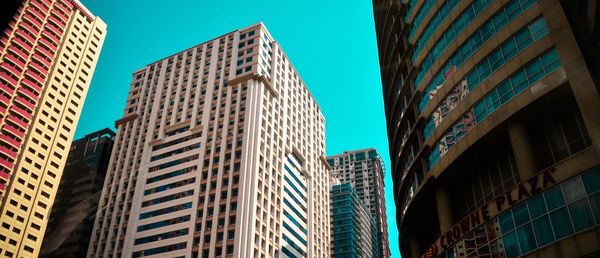 Low angle view of buildings against clear blue sky