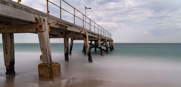 Pier over sea against sky