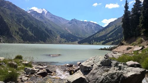 Scenic view of lake and mountains against sky