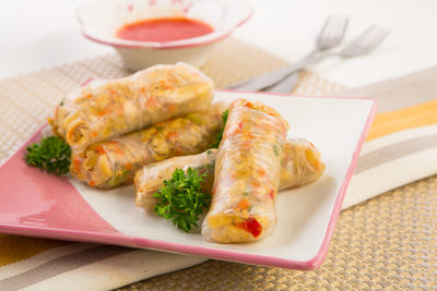 Close-up of spring rolls served in tray