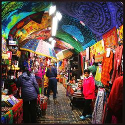 People walking in market stall