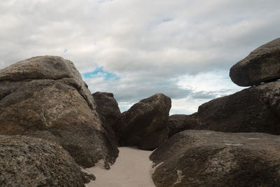 Rock formations by sea against sky
