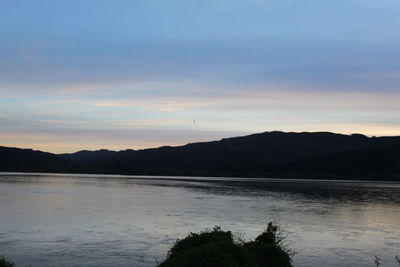 Scenic view of lake against sky during sunset