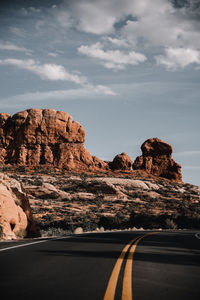 Rock formations by mountain against sky