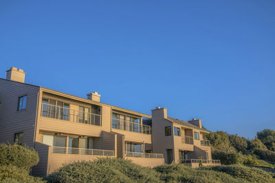 Low angle view of building against clear blue sky