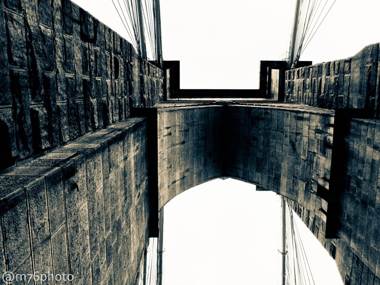 architecture, built structure, connection, low angle view, clear sky, bridge - man made structure, cable, building exterior, power line, sky, arch, bridge, day, outdoors, engineering, no people, wall - building feature, wall, diminishing perspective, electricity pylon