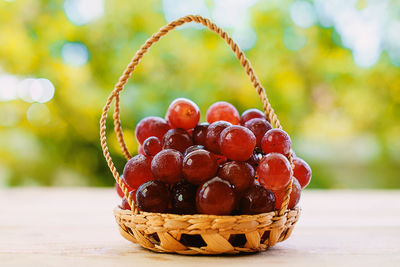 Close-up of grapes in basket on table