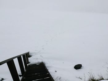 Snow covered shore against sky