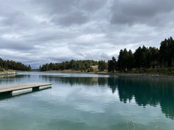 Scenic view of swimming pool by lake against sky