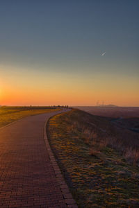 Vertical shot of an empty walkway on top of a hill at halde hoheward during sundown in germany