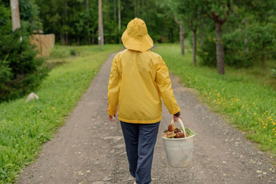 Rear view of woman standing in park