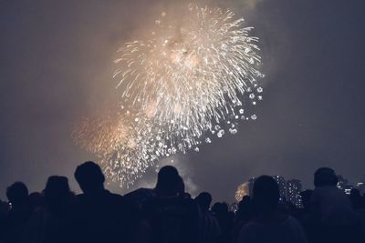 Low angle view of firework display at night