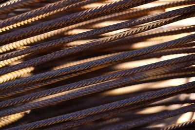 Full frame shot of rusty rebars during sunny day