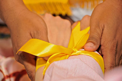 Cropped hand of woman holding tape measure